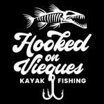 Lush green tropical foliage with palm trees and a view of the blue ocean.