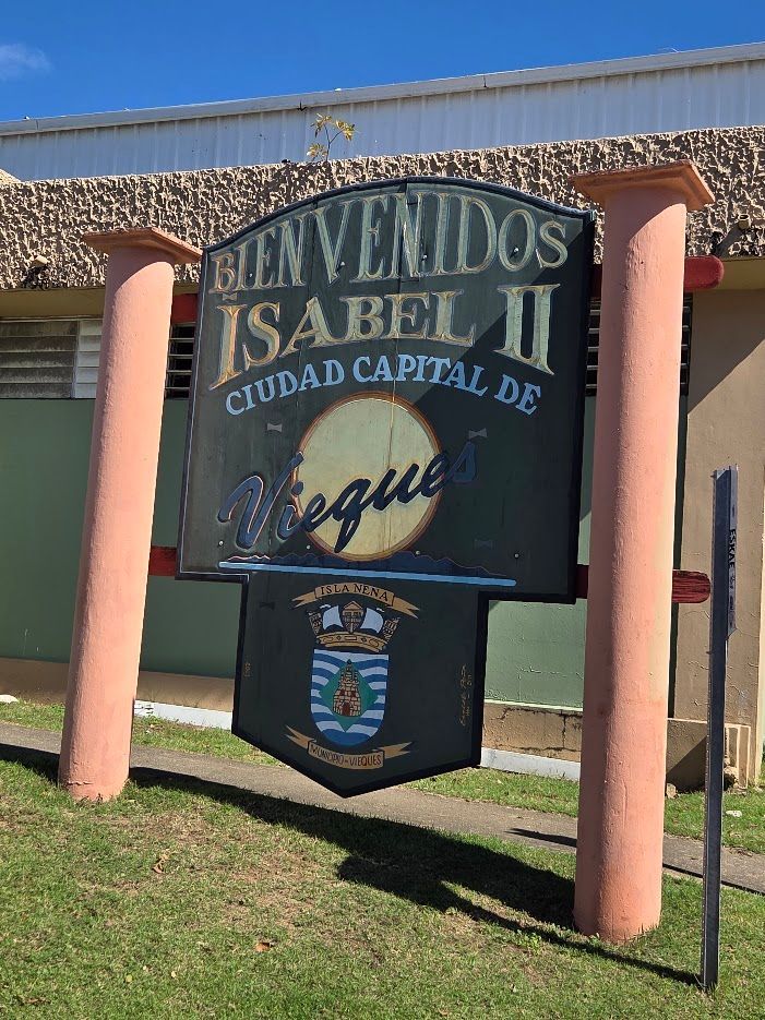 Three people fishing from colorful kayaks in clear tropical water.