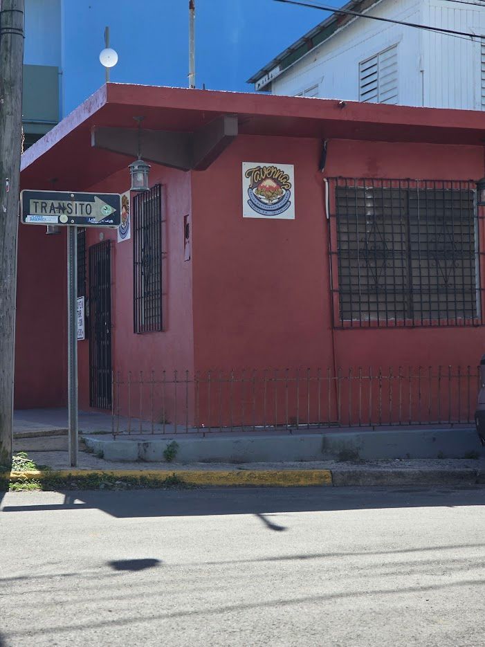 Pizza with pepperoni and basil, alongside glazed chicken wings, on a wooden board.