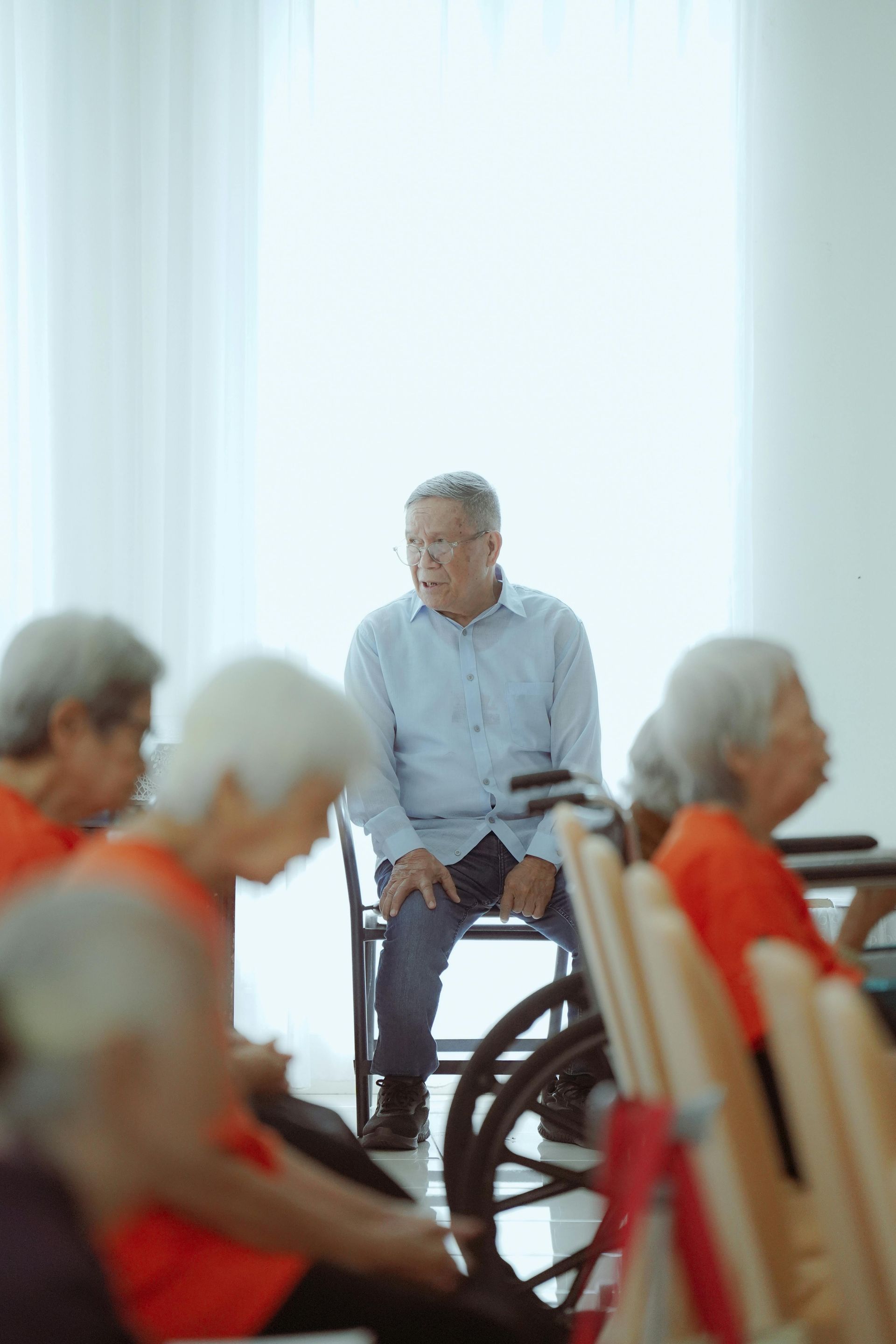 Waiting area with chairs, windows, and a dog statue.