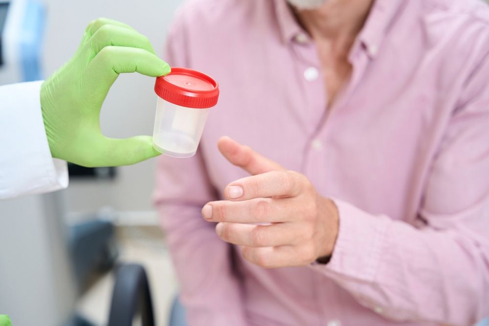 Doctor listening to a young child's chest with a stethoscope in a bright medical office.