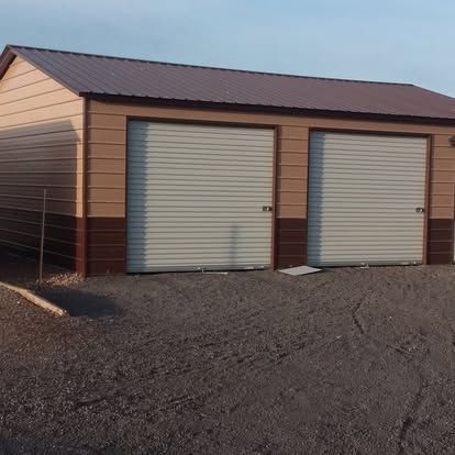 A garage with two garage doors and a brown roof