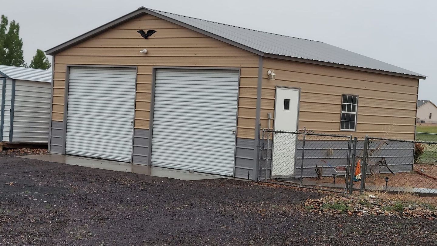 A garage with a roof that has a bird on it