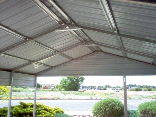 Interior view of steel carport showing galvanized metal framework and roofing panels 