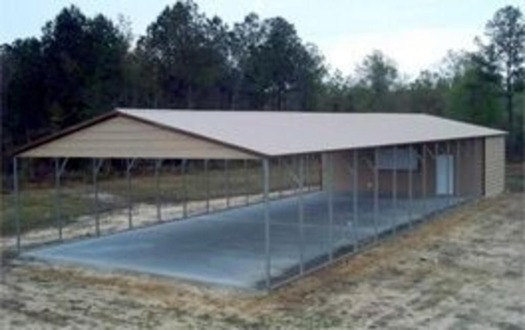 A large metal building with a canopy over a parking lot.