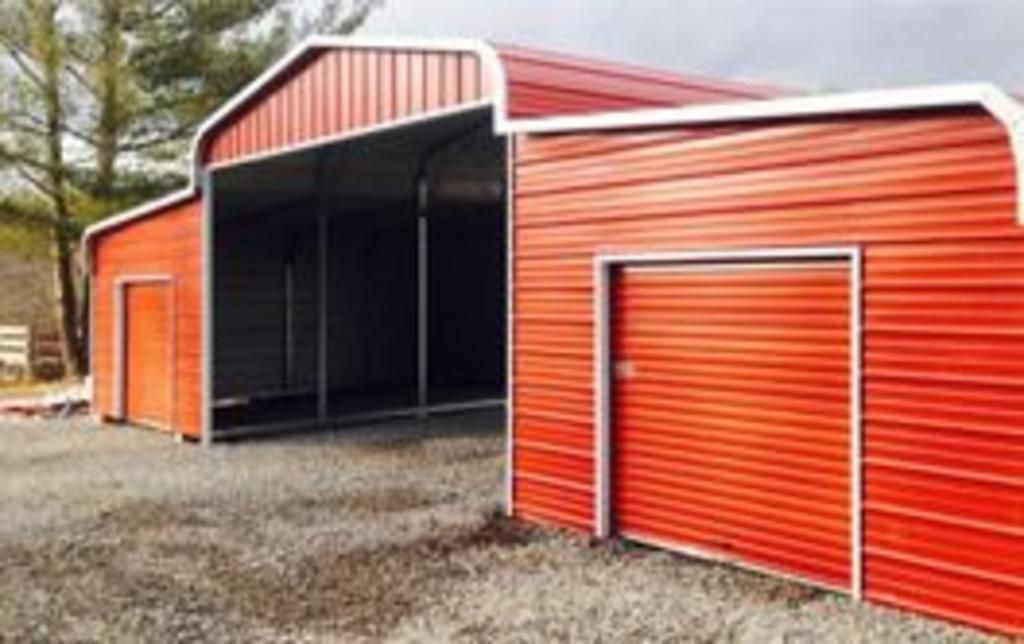 A red barn with a garage attached to it.