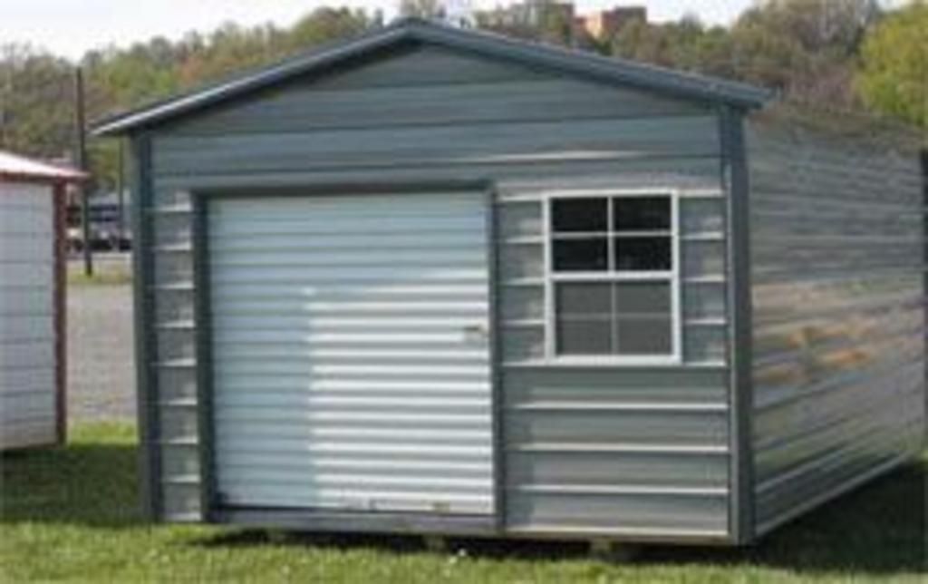 A small metal shed with a window and a roller door.