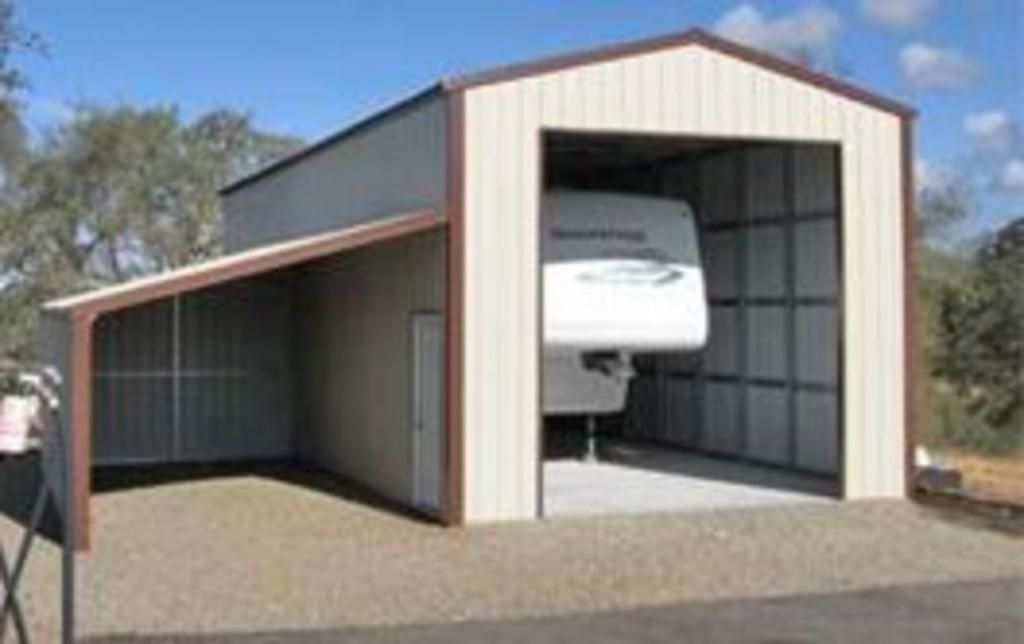 A rv is parked inside of a garage.