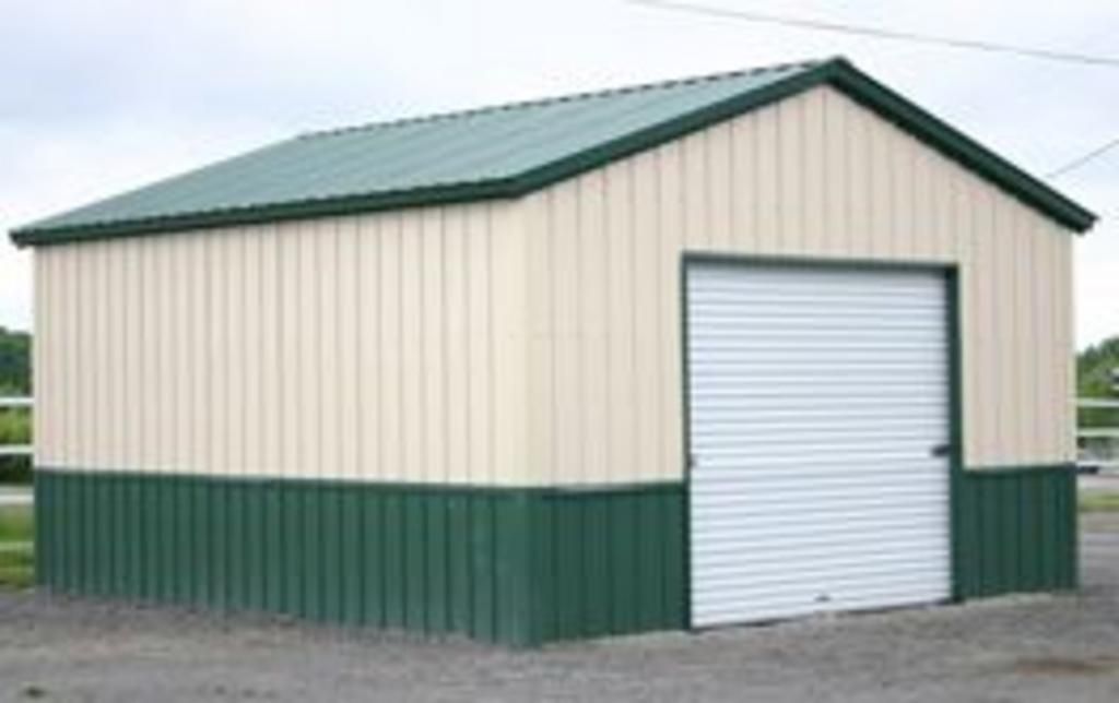 A white and green garage with a white garage door.