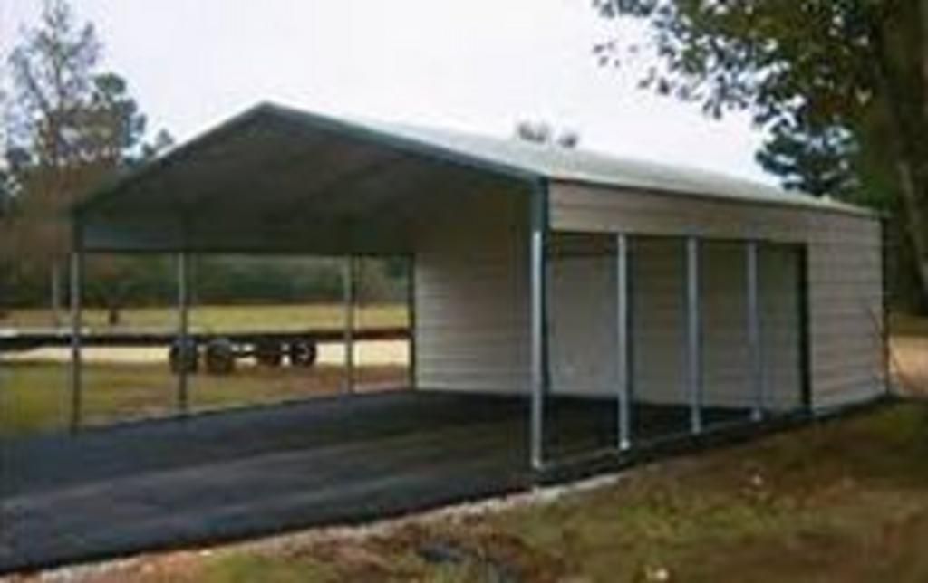 A carport is sitting on the side of a road.