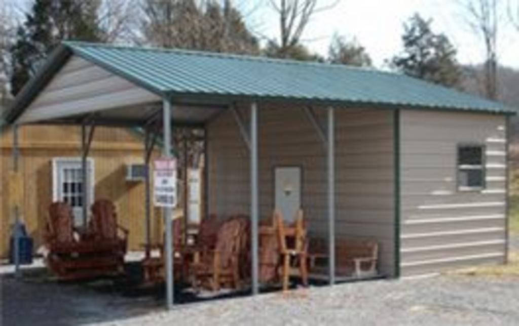 A shed with a green roof and a porch with rocking chairs