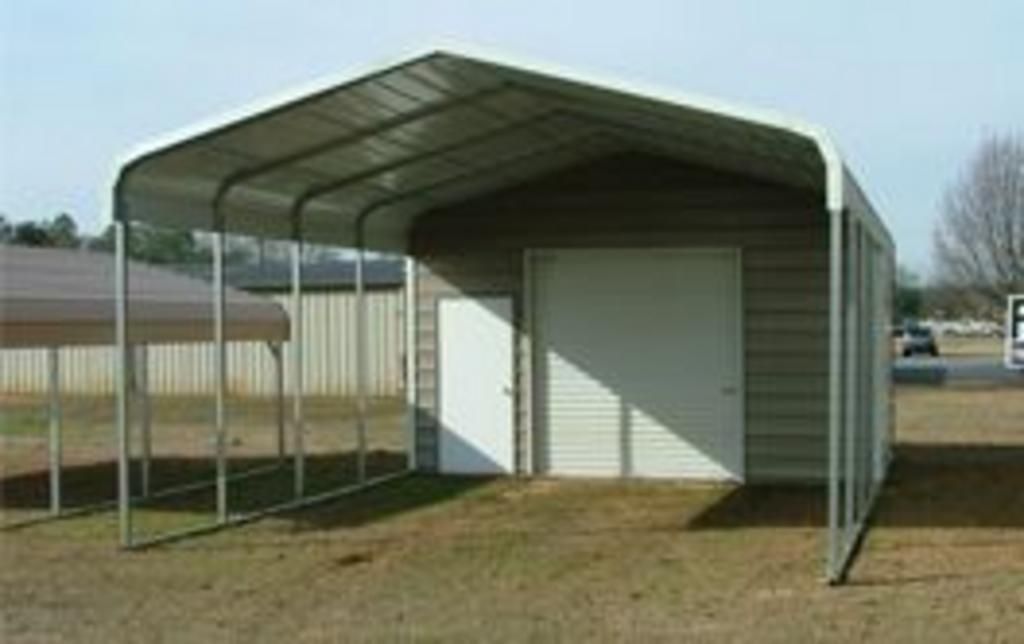 A garage with a canopy over it and a door.