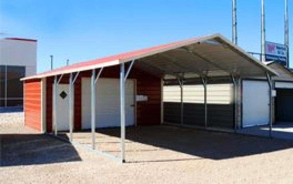 A red and white garage with a canopy over it.