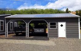 A metal garage with a truck parked inside of it.