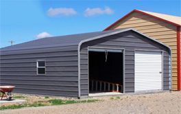 A gray garage with a white door and a window.