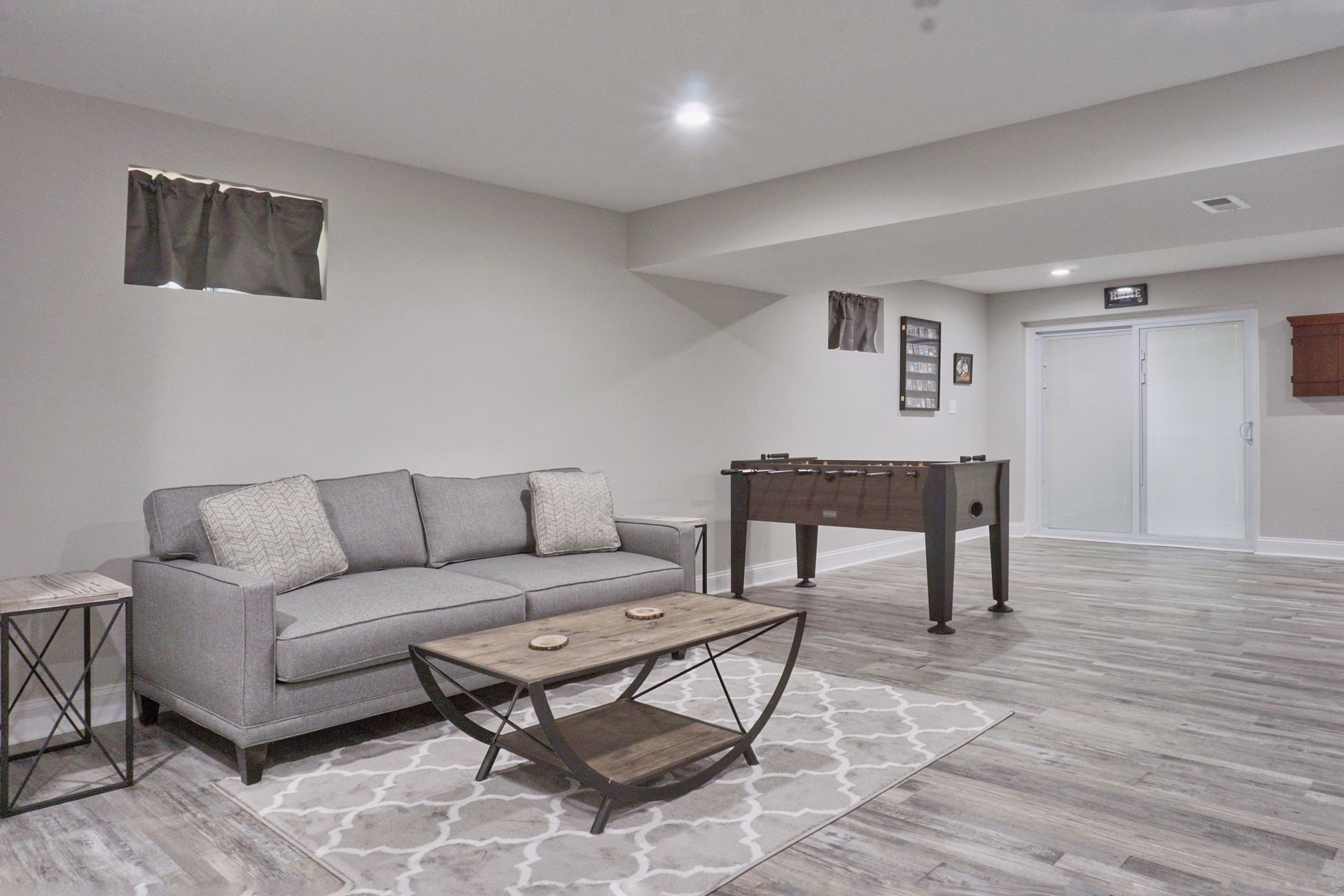 Large basement newly remodeled with a modern interior design and bright lighting.