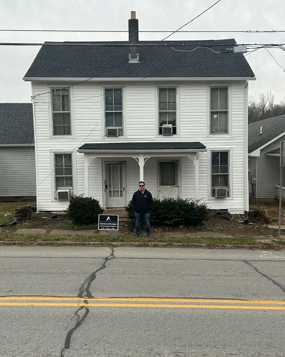 Man in Front of A Simple House — Greenville, IN — Allen's Roofing & Remodeling