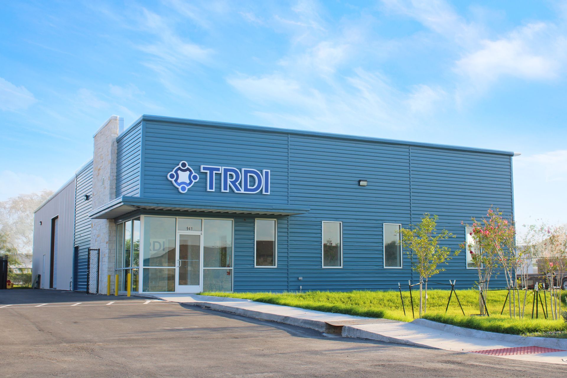 A large white house with a large swimming pool in front of it