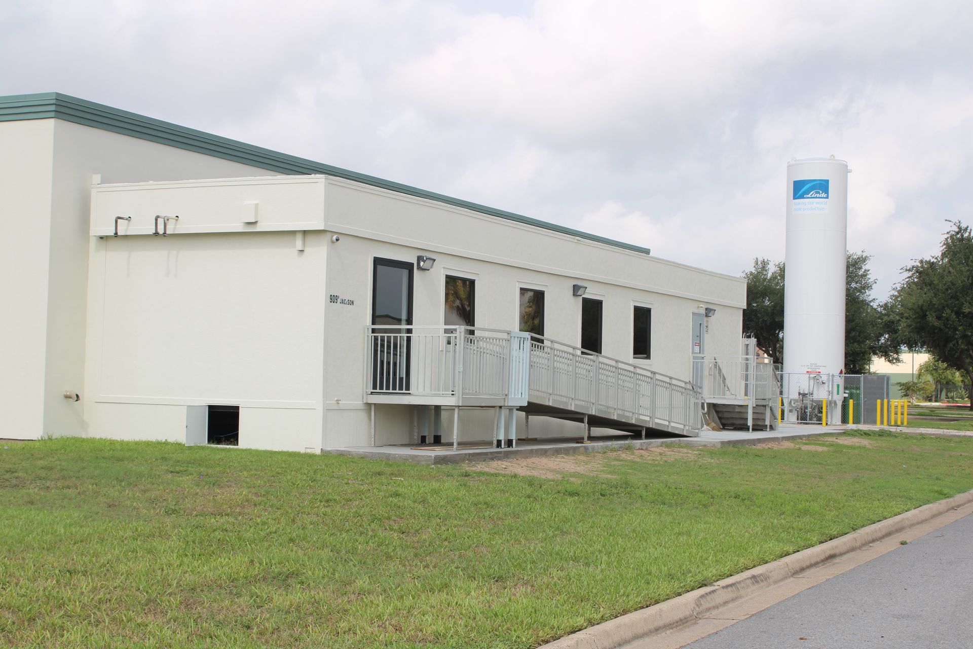 A large white building with stairs leading up to it