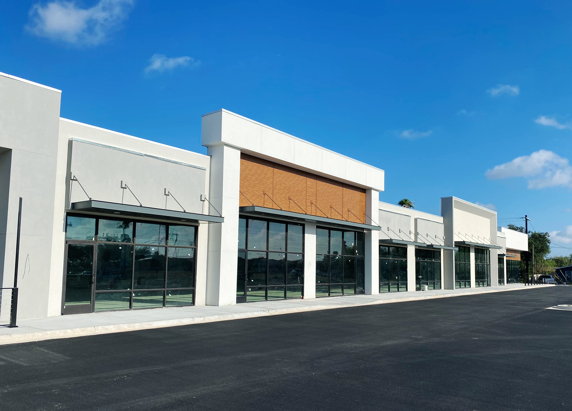 A row of empty buildings with a blue sky in the background.