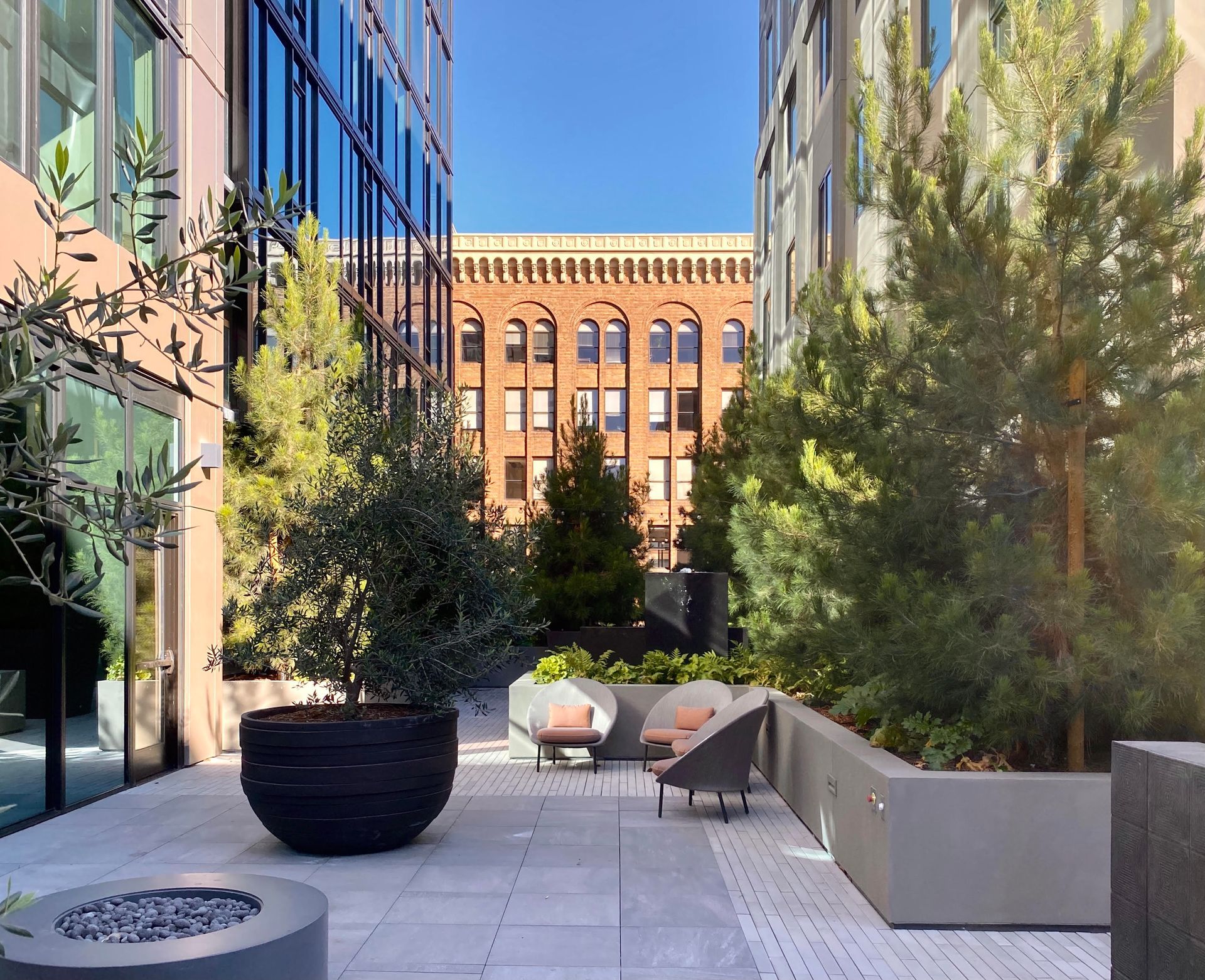 A patio with a fire pit in the middle of a building