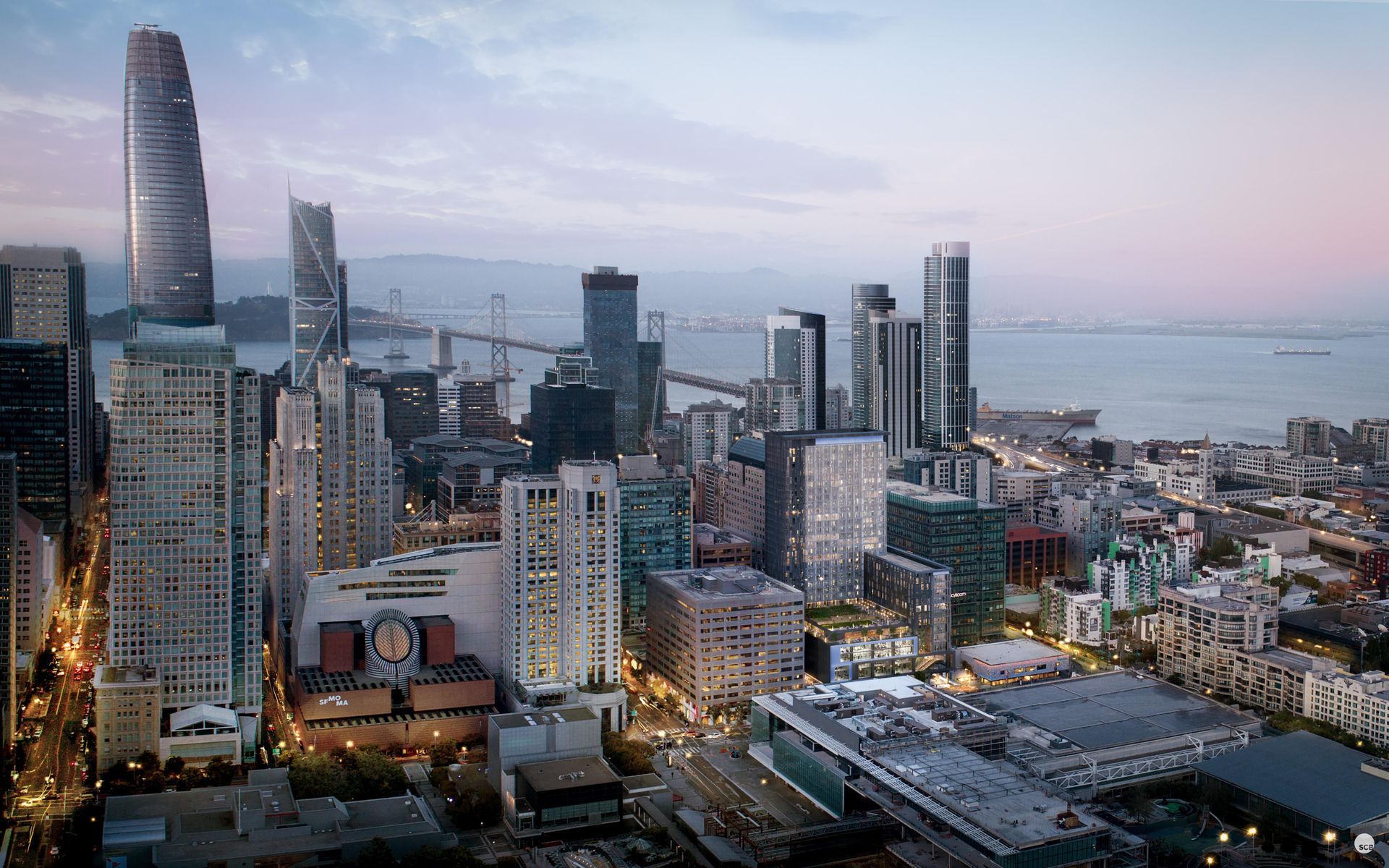 An aerial view of a city with a bridge in the background