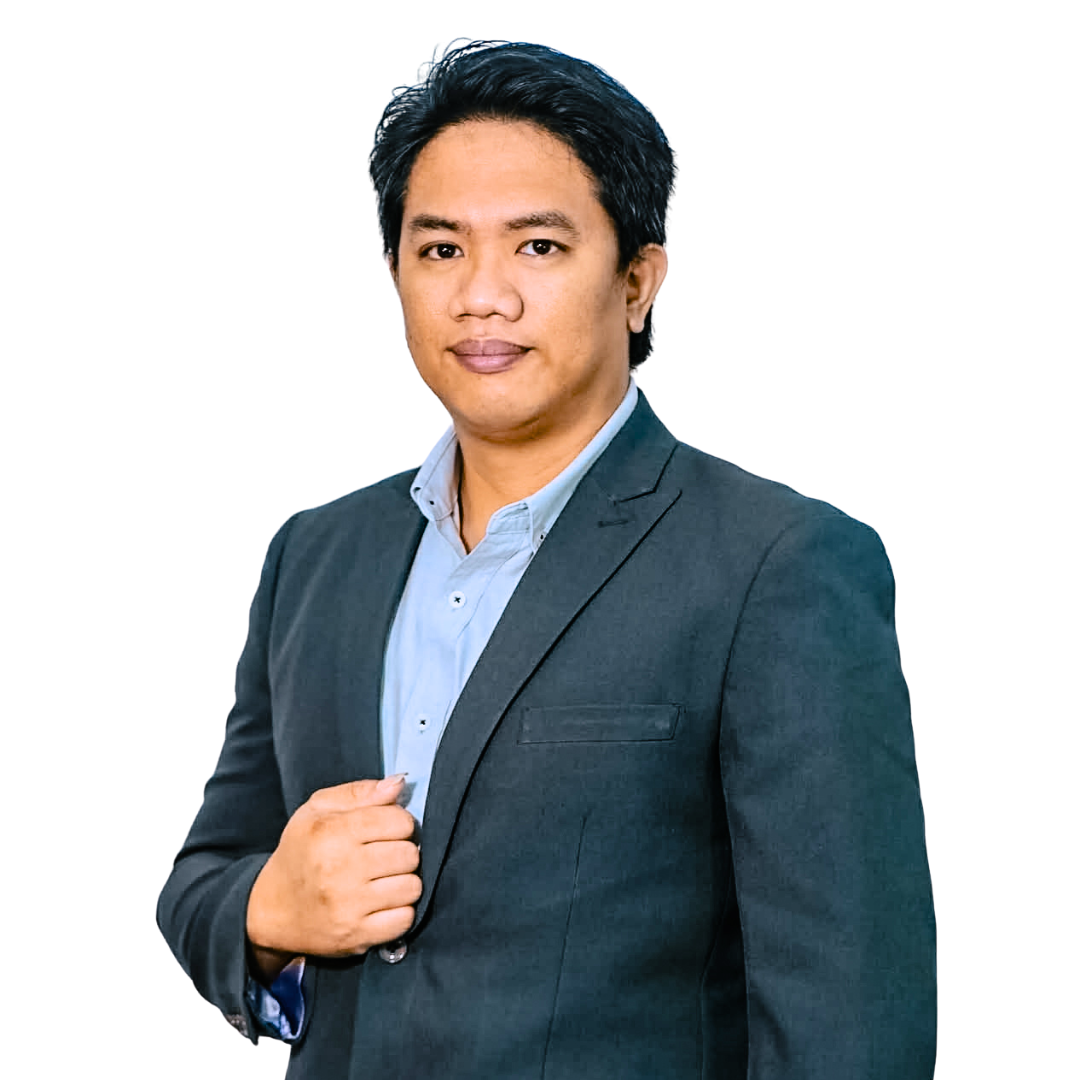 Man in dark suit jacket, light blue shirt, hand on lapel, looking forward.