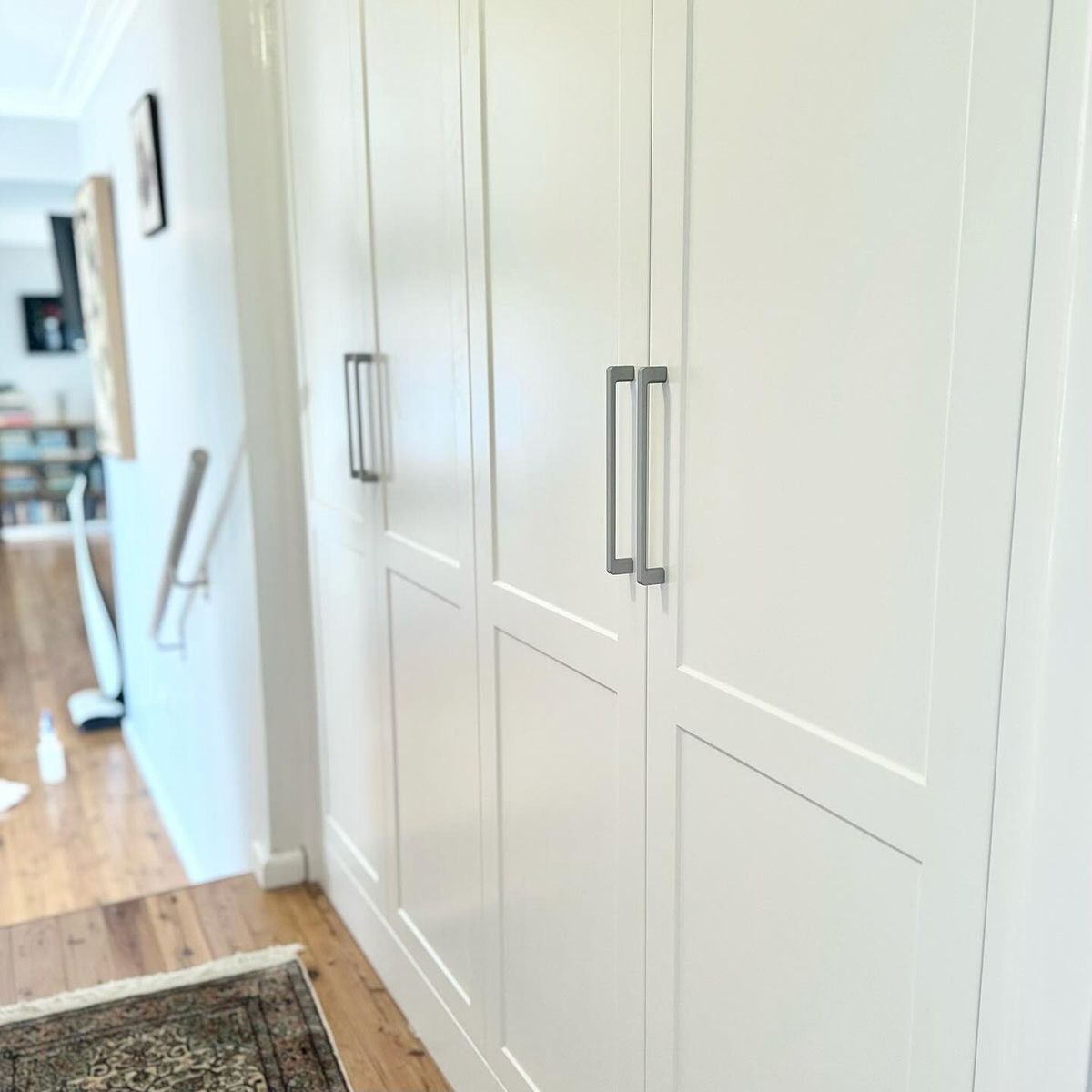 A Hallway With White Cabinets And A Rug On The Floor — Kreuzer Cabinets In East Wagga Wagga, NSW