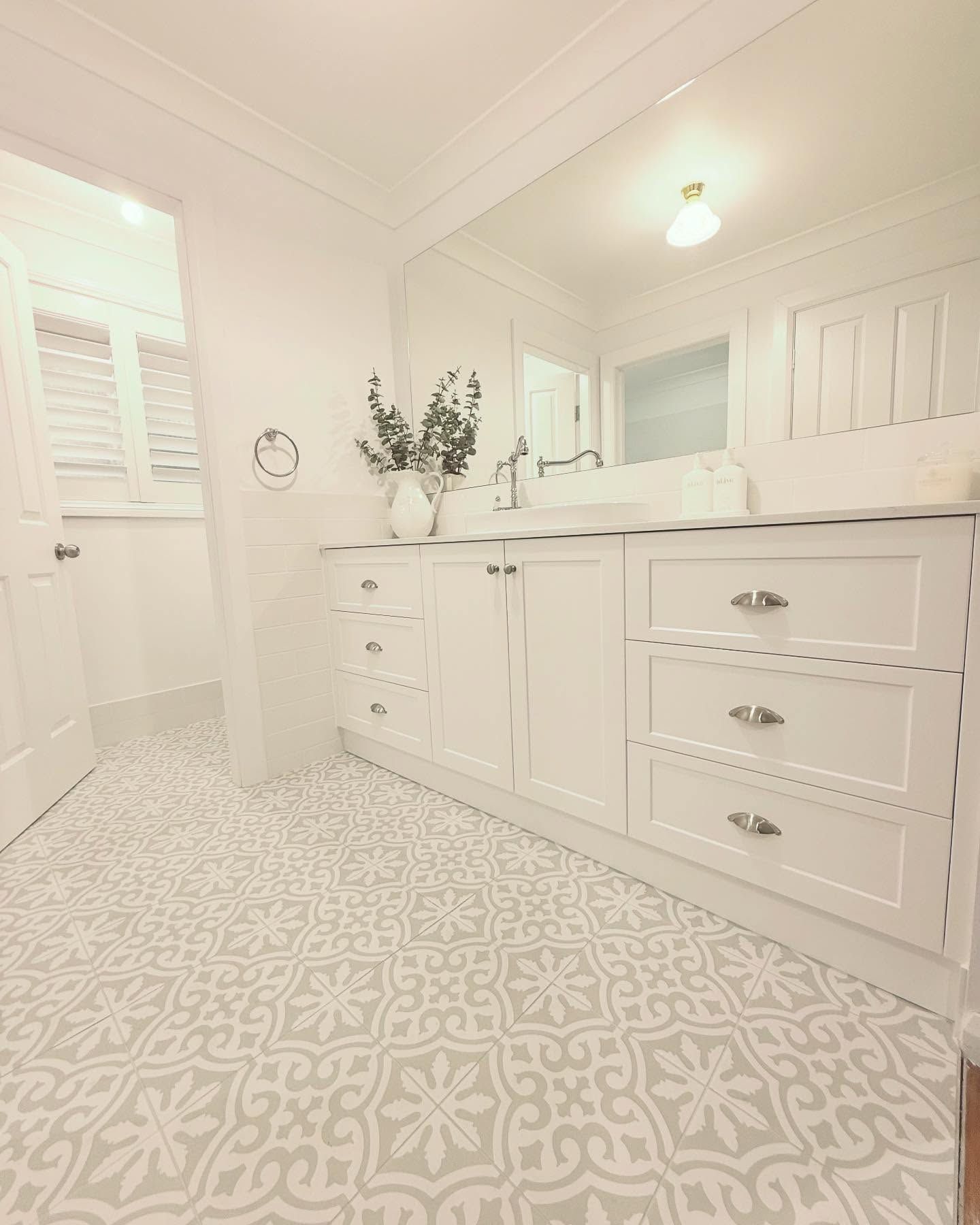 A Bathroom With White Cabinets and Drawers and a Patterned Floor — Kreuzer Cabinets In East Wagga Wagga, NSW