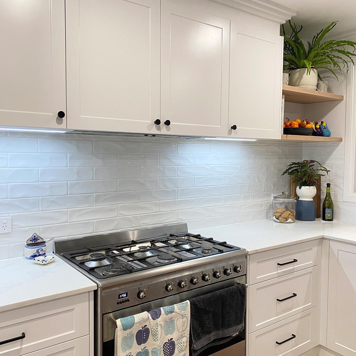 A Kitchen With White Cabinets And A Stove Top Oven — Kreuzer Cabinets In East Wagga Wagga, NSW