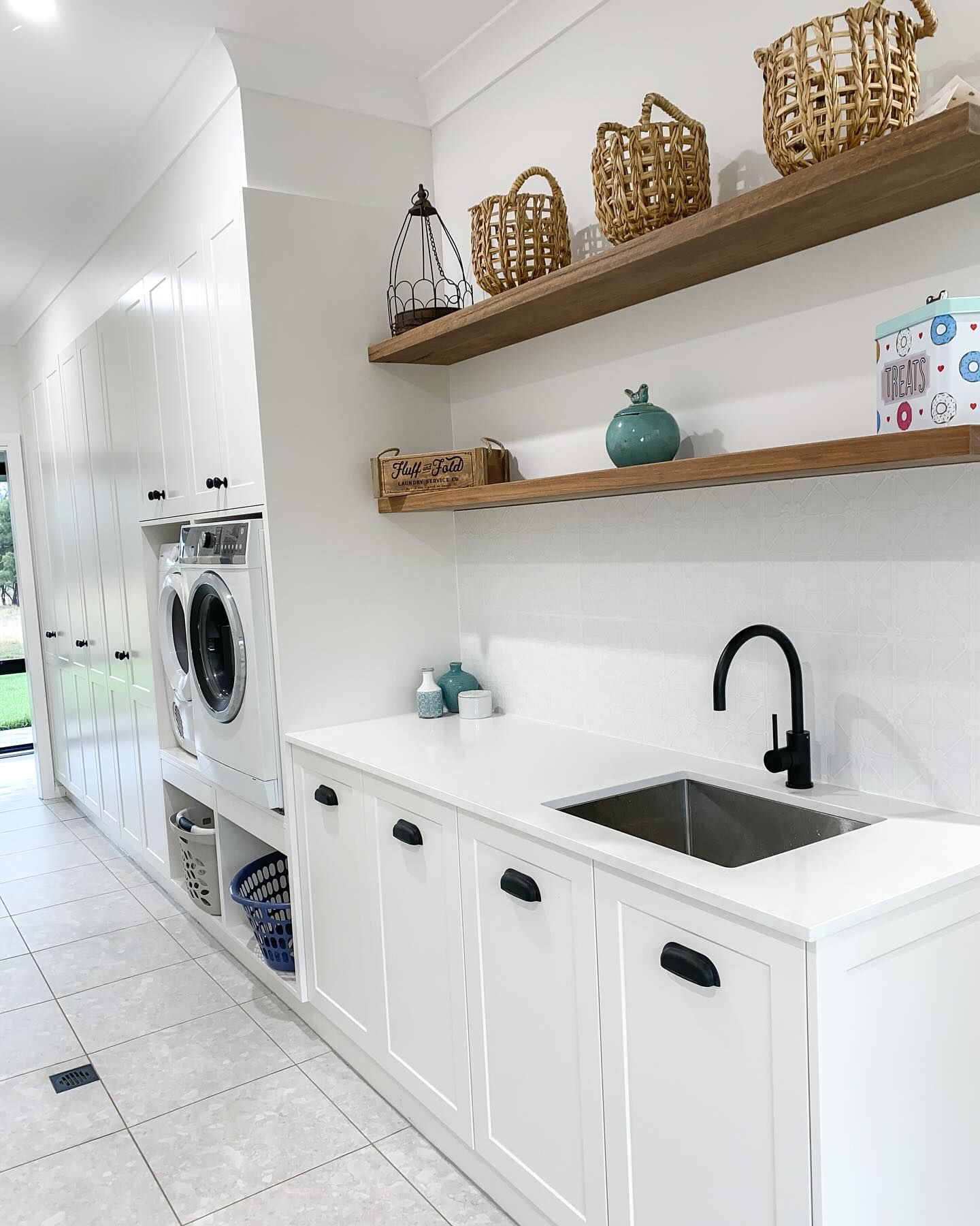 A Laundry Room With a Sink, Washer and Dryer, and Shelves — Kreuzer Cabinets In East Wagga Wagga, NSW