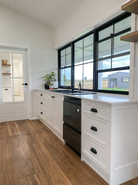 A Kitchen With White Cabinets and a Black Dishwasher — Kreuzer Cabinets In East Wagga Wagga, NSW