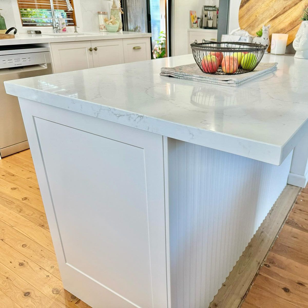 A Kitchen Island With A Bowl Of Fruit On Top Of It — Kreuzer Cabinets In East Wagga Wagga, NSW