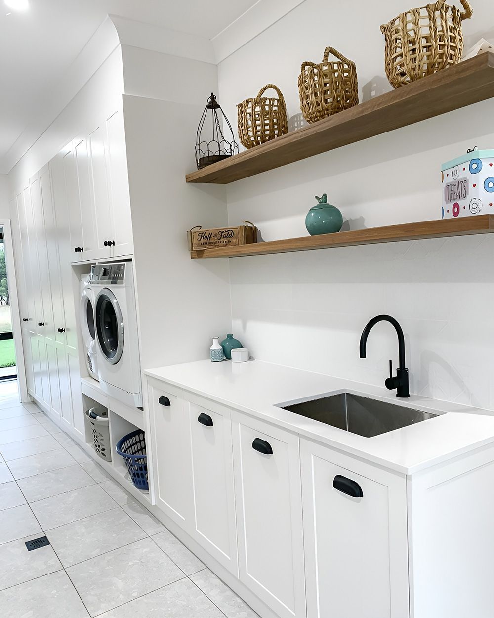 White Kitchen Room with Washer/Dryer, Sink, Cabinets, and Shelves