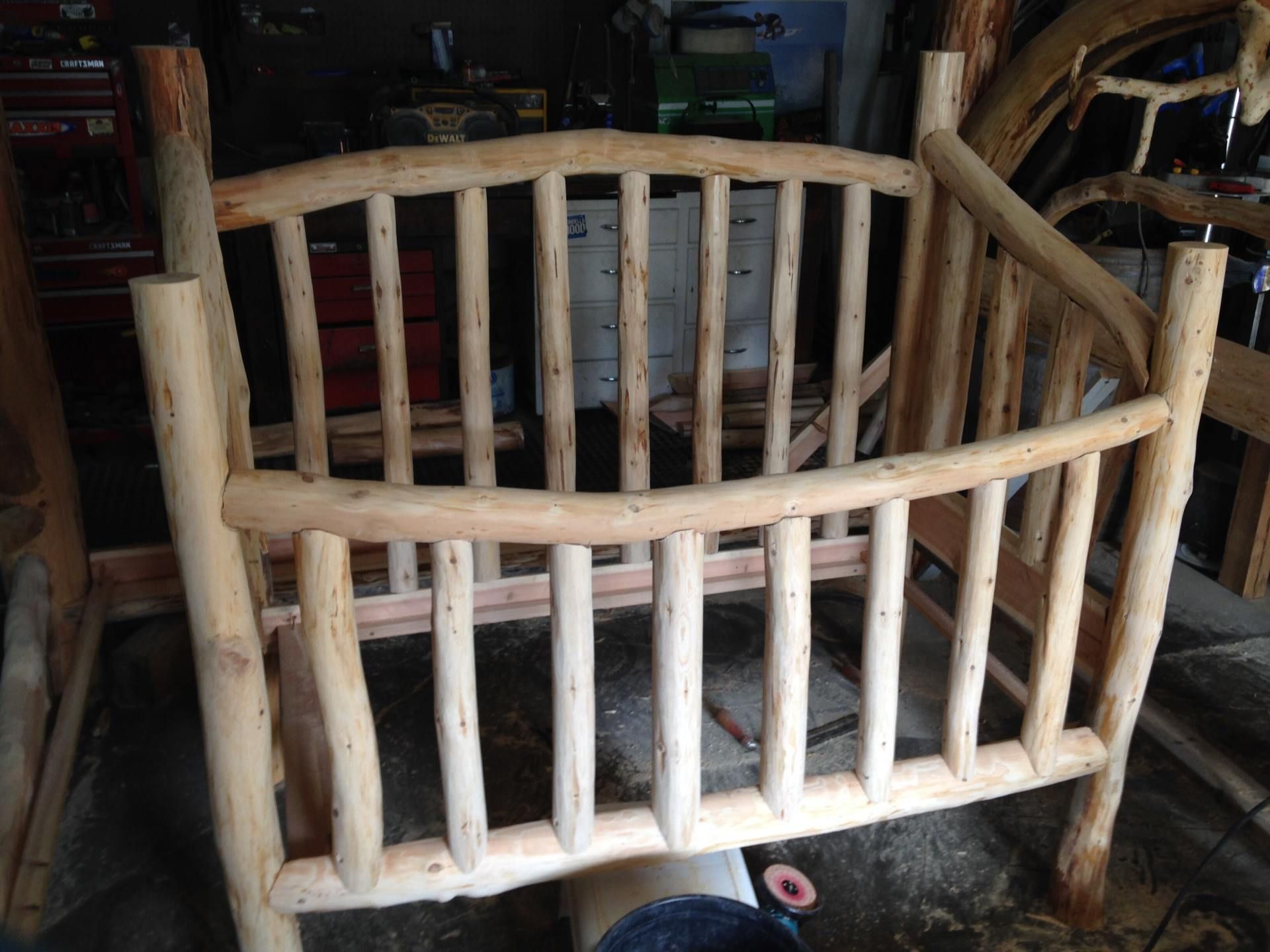 Wooden crib made of natural branches, indoors.