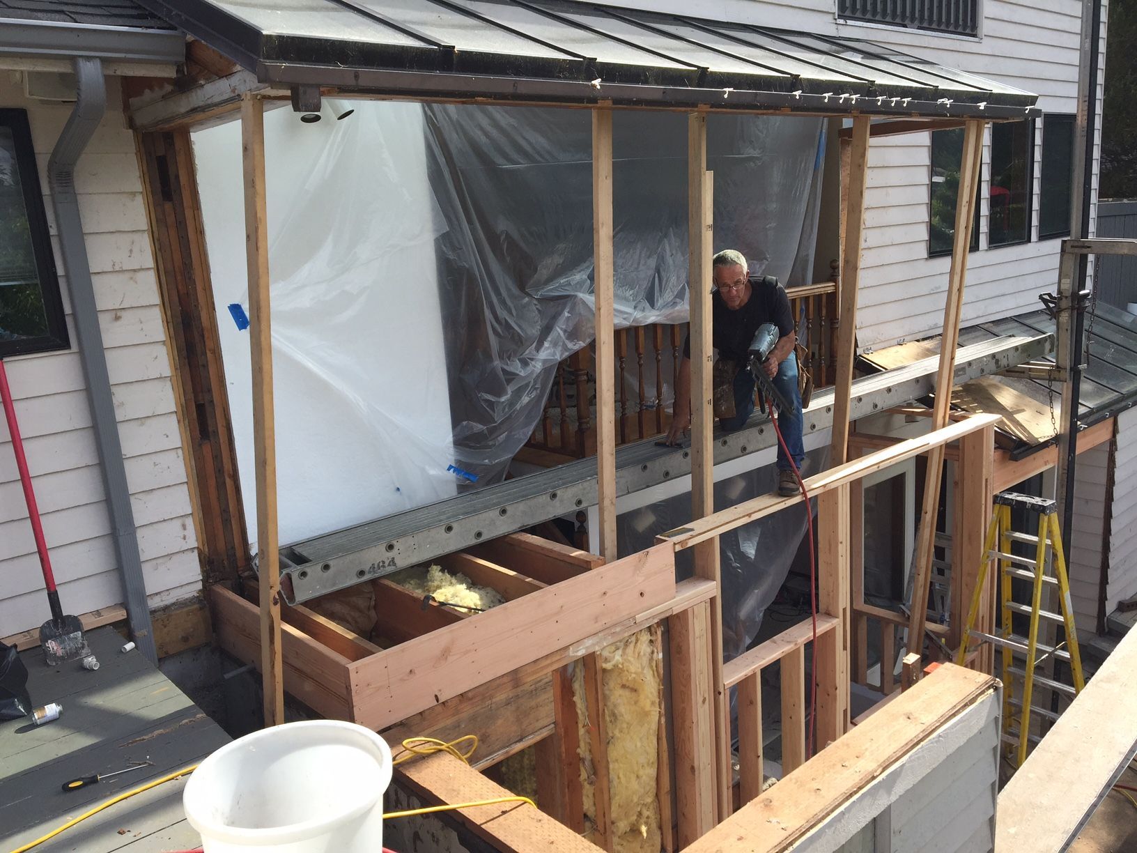 Gray two-story house with a green lawn, white trim, and a two-car garage.