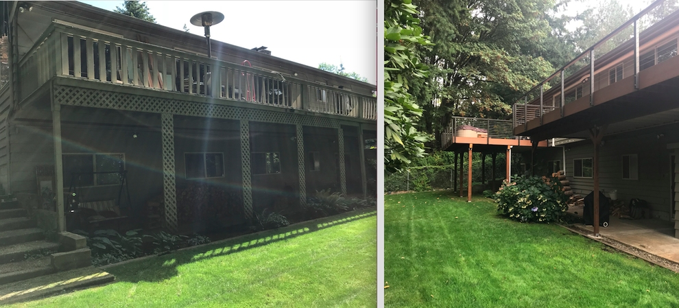 Two-story house with decks, surrounded by green lawn and trees.