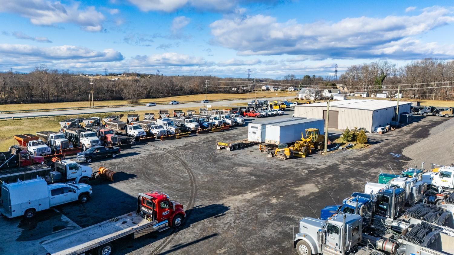 A lot of trucks are parked in a parking lot.