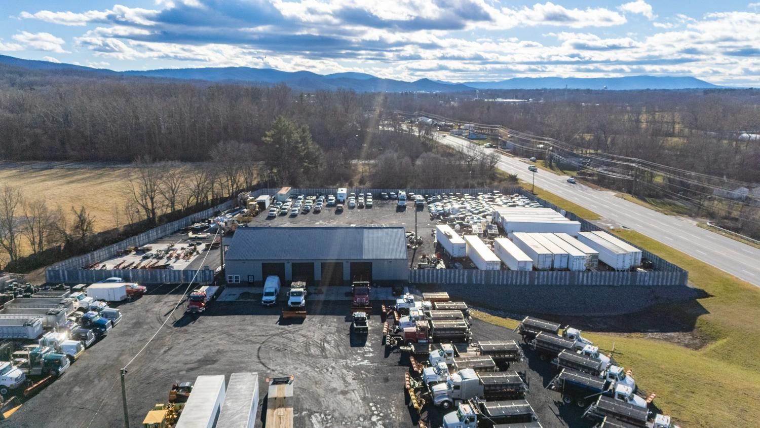 An aerial view of a warehouse filled with trucks and trailers.