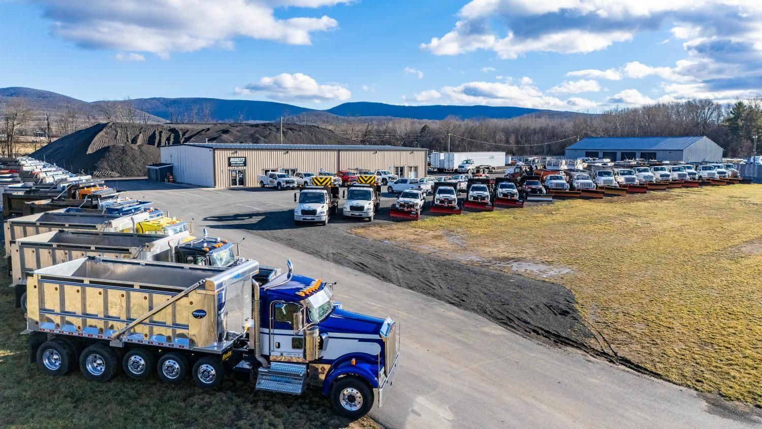 An aerial view of a dump truck parked on the side of a road.