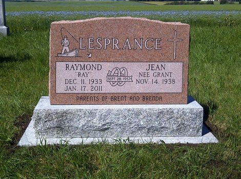Brown gravestone in a grassy cemetery with the name LESPRANCE engraved on top.