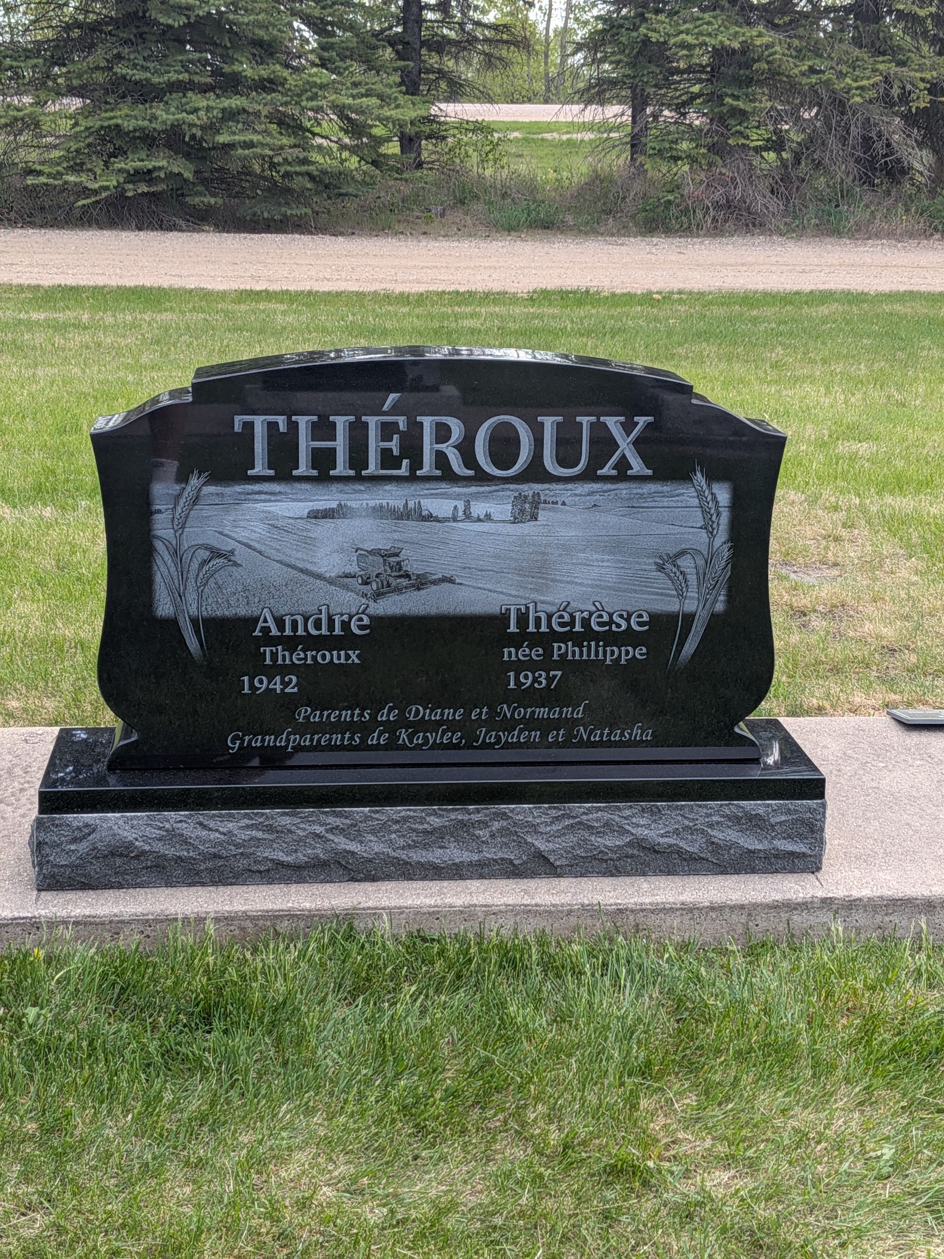Black granite gravestone in a cemetery with the name “THÉROUX” engraved on it.