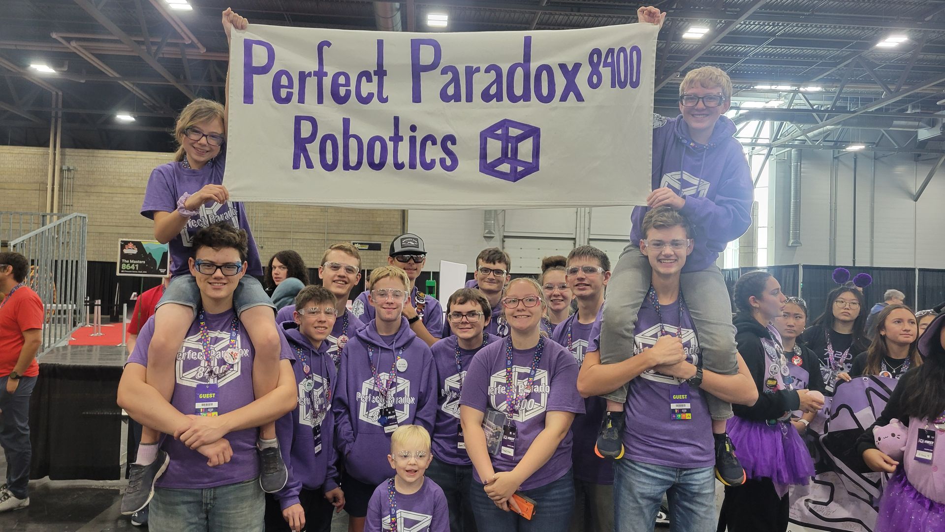 A group of children are sitting at a table playing with toys.