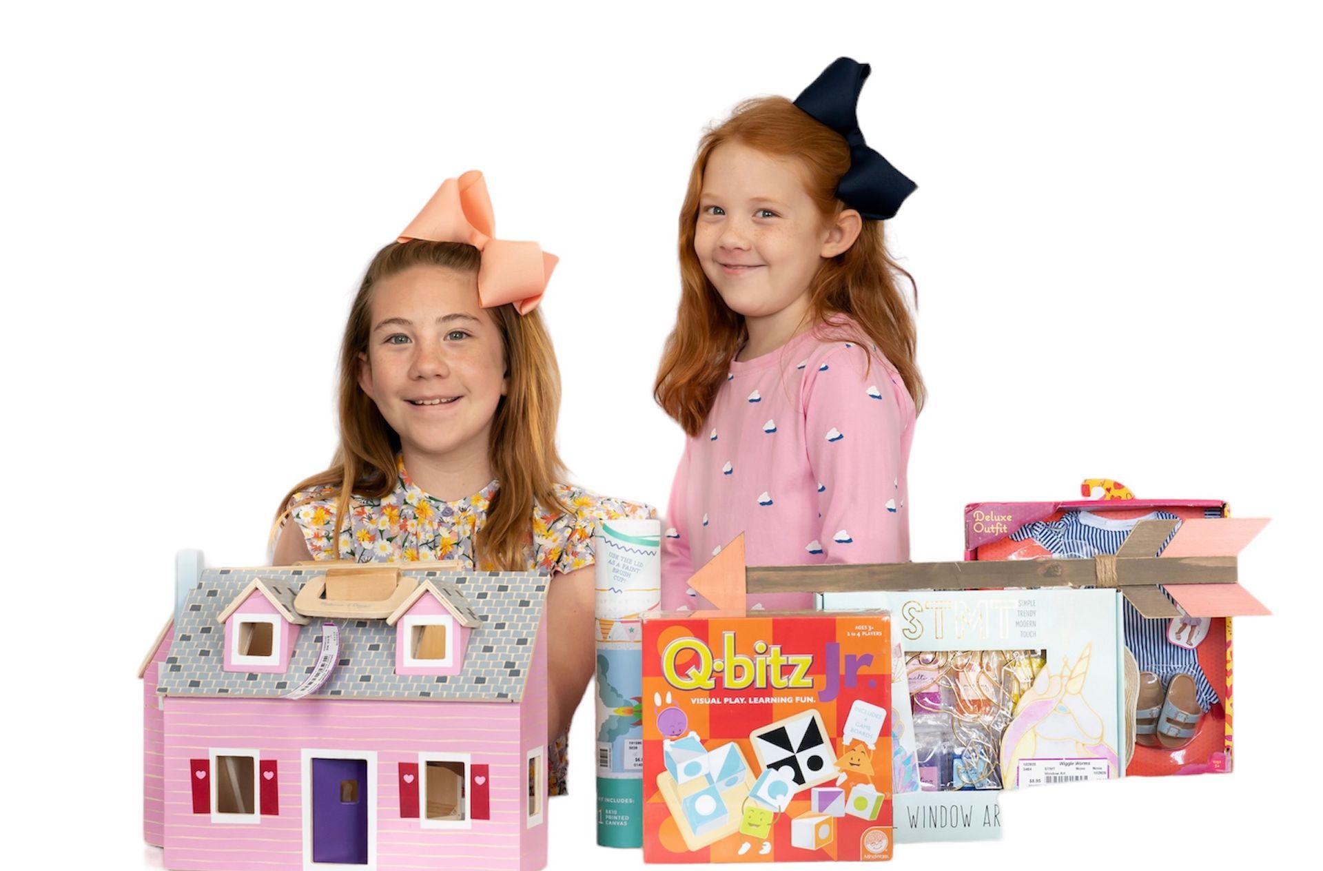 image of two girls with bows in their hair playing with some toys