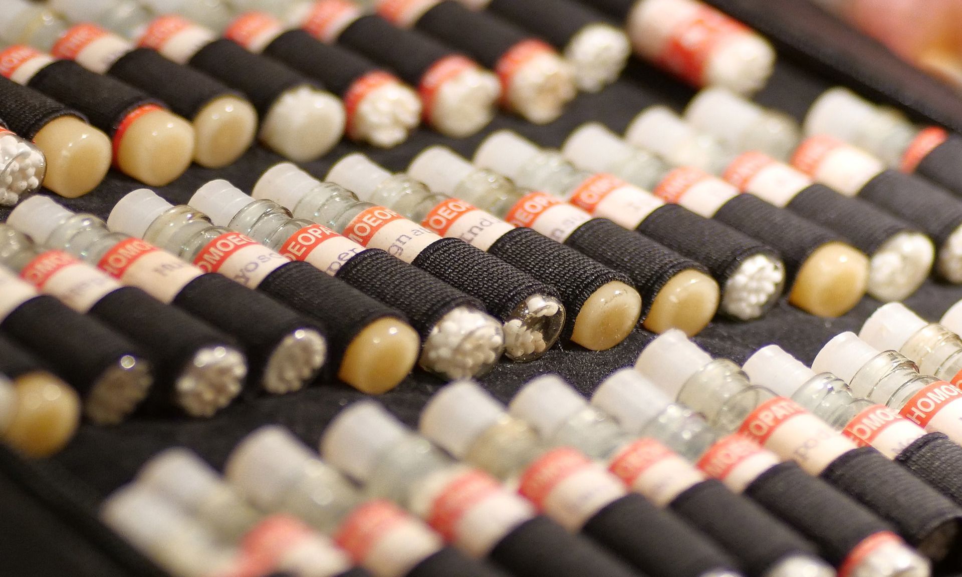 A bunch of bottles of perfume are lined up on a table.