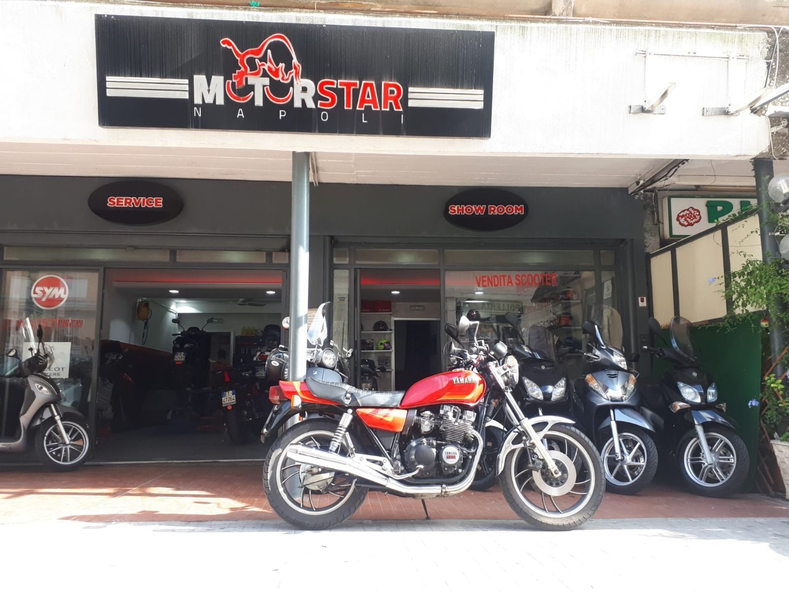A motorcycle is parked in front of a store.