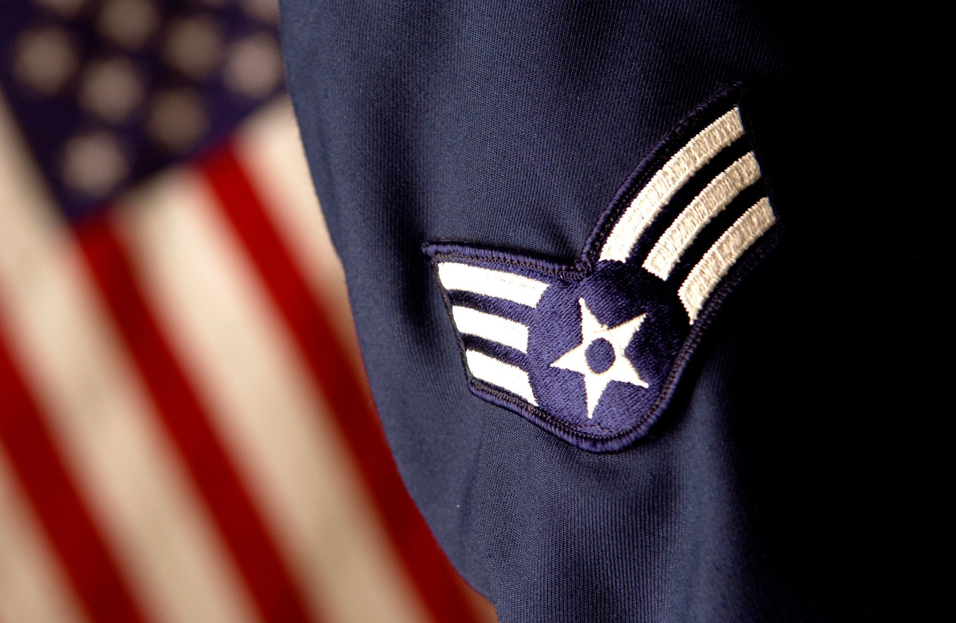 a close up of a military uniform with an american flag in the background