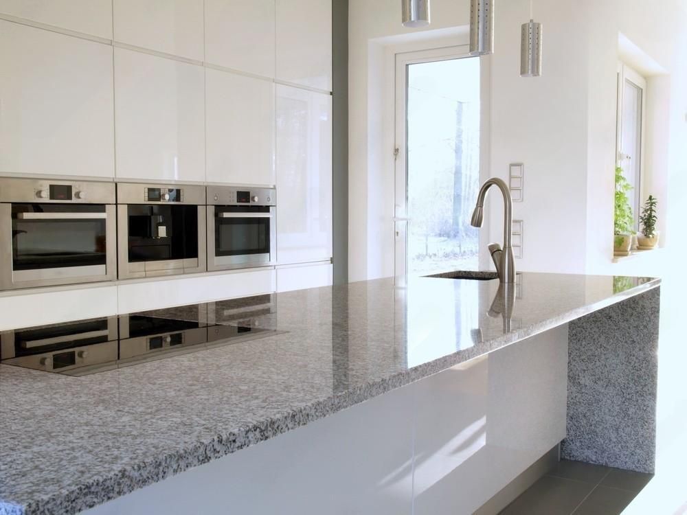 A kitchen with granite counter tops and stainless steel appliances