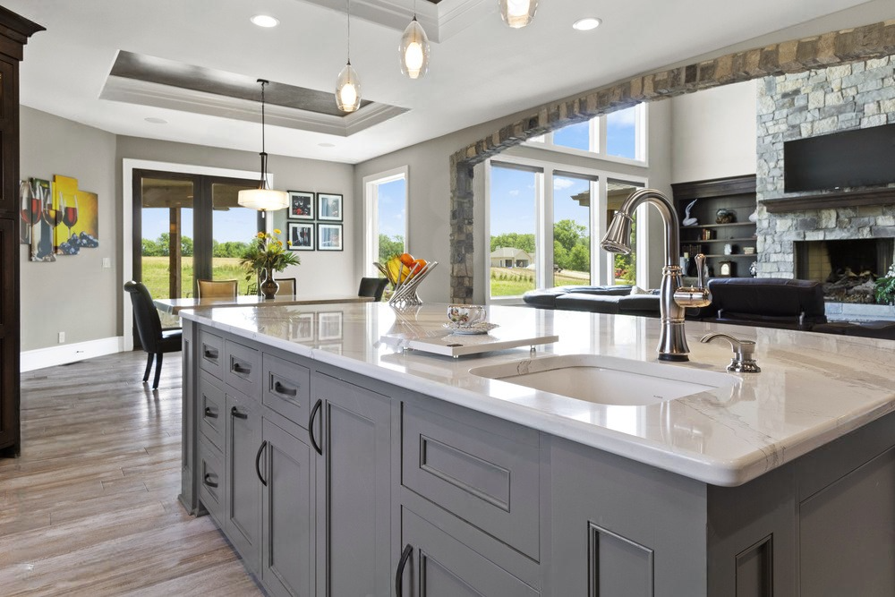 A kitchen with a large island and a sink.