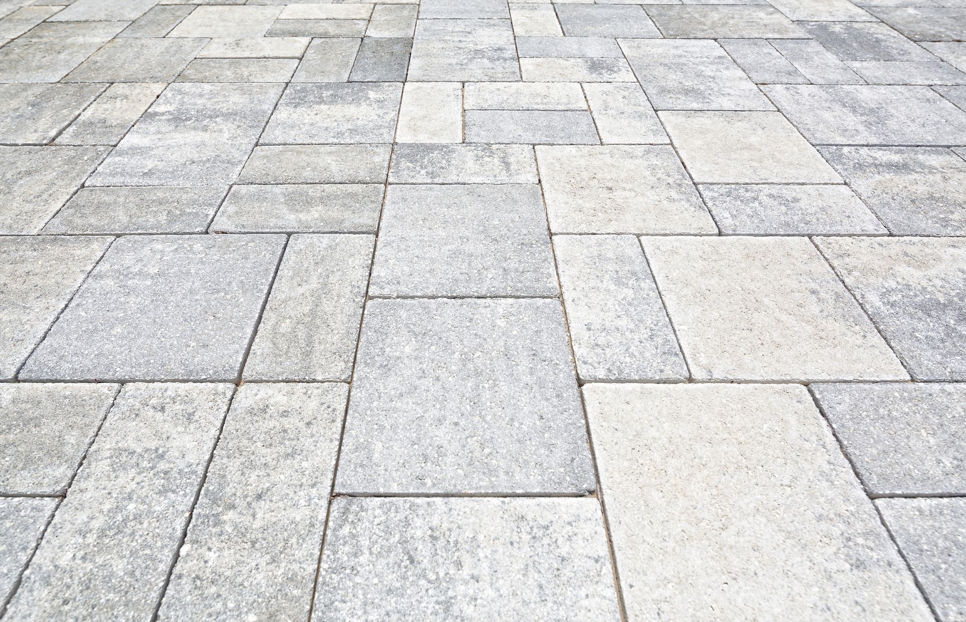 Gray and white rectangular paving stones in a random pattern, angled perspective.